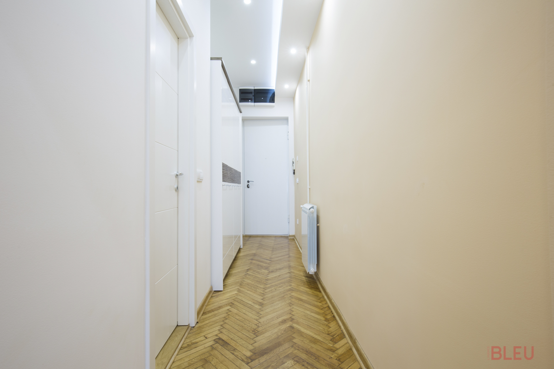 Dans les appartements haussmanniens, les longs couloirs aveugles peuvent être transformés pour optimiser l'espace. Vous pouvez les diviser en utilisant des crochets ou des formes en S pour créer une impression de changement de pièce. Changer la couleur des murs ou du sol renforce cet effet. En retirant une cloison, vous pouvez ajouter des espaces de rangement le long du couloir, le transformant en une pièce fonctionnelle plutôt qu'un simple passage. L'ajout d'une verrière apporte de la lumière naturelle et crée un élément qui rompt la linéarité du couloir.