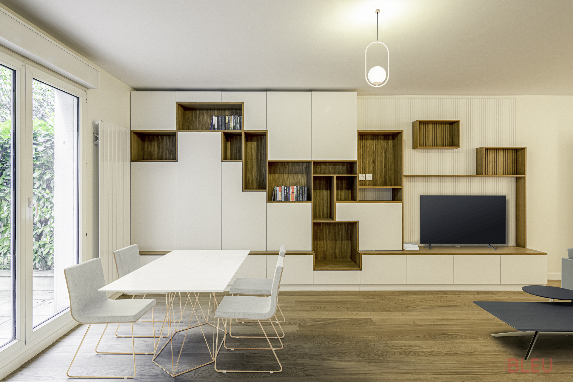 Espace de vie moderne et minimaliste dans un duplex parisien, avec coin repas élégant et rangements intégrés.